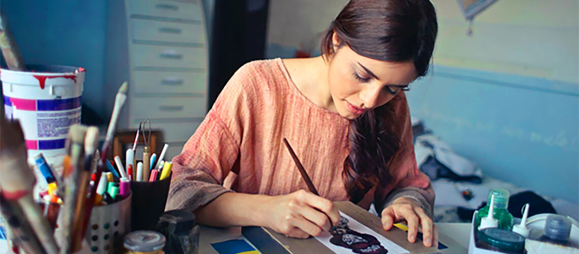 Artist at a table painting