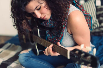Woman Playing a Guitar