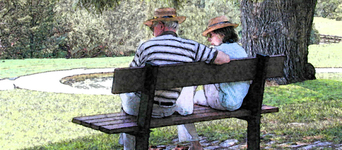 A couple on a park bench