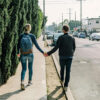 A couple walking down the sidewalk.