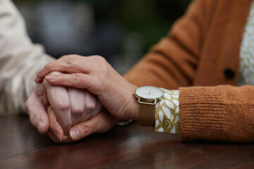 Friends holding hands in support