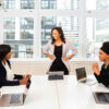 Woman director talking to associates in a board room.