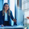 A woman and man working in a tech office.