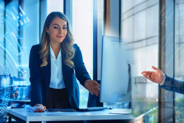 A woman and man working in a tech office.