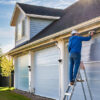 Man painting on a ladder.