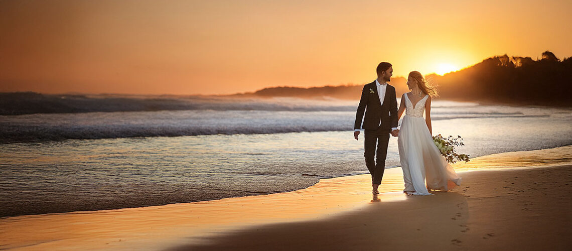 Couple walking on beach in Australia